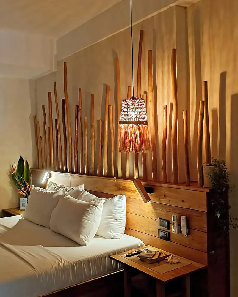 Deluxe King room with bamboo headboard and warm lighting